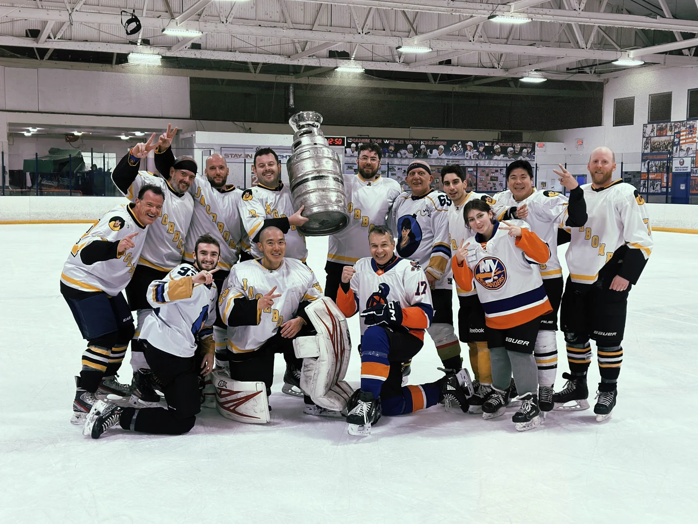 Jagr Bombs celebrating their Fall 2025 championship with the cup.
